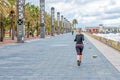 BARCELONA, SPAIN - MARCH 13: Woman jogging in Barcelona near to the sea