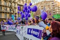 Barcelona, Spain - 8 march 2019: women chanting and calpping in the city during woman`s day with purple balloons