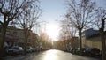 Barcelona, Spain - May, 2018: Lively Park alley with houses. Art. View of residential area with asphalt alley, trees
