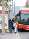 Barcelona, Spain - May 2019. People board the bus near Barcelona's beach Royalty Free Stock Photo