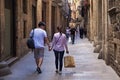 BARCELONA, SPAIN - MAY 15, 2017: Unknown young coiple walking in the Carrer de Montcada street in historical Gothic quarter of