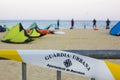 Barcelona, Spain, May 23 2020: view through the closed beach fence on shore and kitesurfers on the Mar bella Barcelona beach.