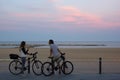 A young couple with bicycles near closed beach of Barcelona Royalty Free Stock Photo