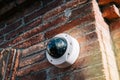 Axis 360 degrees surveillance camera on brick wall