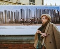 Senior woman walking near Kai Wiedenhofer exibition about separating walls