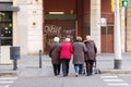 BARCELONA, SPAIN - NOVEMBER 12, 2019: Four old women friends crossing the street holding hands. Frendship aging concept