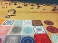 Barcelona, Spain, November 2016: illegal seller sell carpets on beach