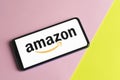 Barcelona , Spain- November 5 , 2020: Xiaomi Smartphone with Amazon logotype on colorful pink and yellow background.Amazon is a e-