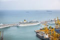 BARCELONA, SPAIN - OCTOBER 15, 2018: Beautiful view on the Barcelona port. Green hills of the Montjuic mountain. Industrial ships