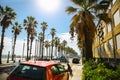 BARCELONA, SPAIN - OCTOBER 15, 2018: Busy street with cars in Barcelona. High palm trees near the beach and bright sun. Holiday Royalty Free Stock Photo