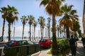 BARCELONA, SPAIN - OCTOBER 15, 2018: Busy street with cars in Barcelona. High palm trees near the beach and bright sun. Holiday Royalty Free Stock Photo