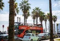 BARCELONA, SPAIN - OCTOBER 15, 2018: Busy street with cars in Barcelona. Red tourist bus on the road. High palm trees near the Royalty Free Stock Photo