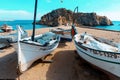 Barcelona, Spain-October 12, 2022. Costa Brava beach, fishing boats and Sa Palomera rock in the village of Blanes, Spain Royalty Free Stock Photo