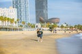 BARCELONA, SPAIN - OCTOBER 15, 2018: Couple hugging on the Barcelona beach. Summer vacations travel. Barceloneta on sunny day. Royalty Free Stock Photo