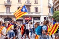 BARCELONA, SPAIN - OCTOBER 18, 2019: A man raising catalan flag is walking on the street during protests in Catalonia. Pro-Catalan