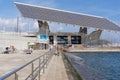 Older people sunbathing on some benches in the port of the Forum in Barcelona