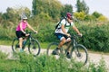 A pair of Mature cyclists on a walk in the Park