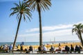 BARCELONA, SPAIN - OCTOBER 15, 2018: Street near the beach in Barcelona. Palm trees and many people. Tourists relaxing. Holiday Royalty Free Stock Photo