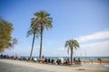 BARCELONA, SPAIN - OCTOBER 15, 2018: Street near the beach in Barcelona. Palm trees and many people. Tourists relaxing. Holiday Royalty Free Stock Photo