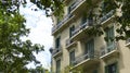 Old building in barcelona ornated balconies and trees Royalty Free Stock Photo