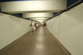 BARCELONA / SPAIN - 28/08/2014 pedestrian underground passage tunnel with a brown floor and white walls in the city center with Royalty Free Stock Photo