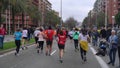 people run a marathon on a city street.