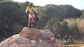 rider on a huge stone during a motorcycle trial.