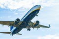 White and blue Ryanair aircraft with landing gear ready to land at Barcelona airport in Spain Royalty Free Stock Photo