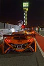 Night in the pitlane of 24hours Series Barcelona race vertical