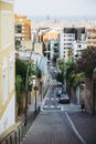 Barcelona street in Gracia district near Park Guell, hilled street Royalty Free Stock Photo