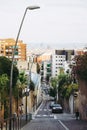 Barcelona street in Gracia district near Park Guell, hilled street Royalty Free Stock Photo