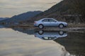 Swamp and a travel saloon car reflected in the water, Ford Mondeo Mk3 Royalty Free Stock Photo