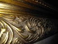 Barcock golden frame made of wood on a black background.