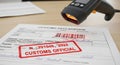 Barcode scanner illuminates a customs declaration form with a bold red official stamp, symbolizing international trade clearance Royalty Free Stock Photo