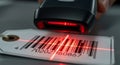 Barcode scanner reads product information on a tag with a bright red laser light beam Royalty Free Stock Photo
