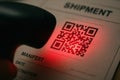 Barcode Scanner Scanning QR Code on Shipment Manifest Document with Red Laser Light Royalty Free Stock Photo