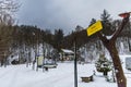 Mountain landmark in Bardo city with small tree and hanging yellow board next to car parking