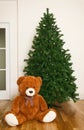 Bare artificial christmas tree with teddy bear Royalty Free Stock Photo