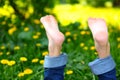 Bare boy feet on the summer green grass Royalty Free Stock Photo