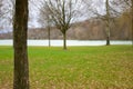 Bare branched trees and lake in an autumn park