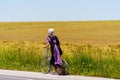 Bare feet Amish Girl Uses Bicycle Scooter