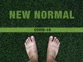 Bare feet on artificial green grass with text. Royalty Free Stock Photo