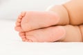 Bare feet of a baby sleeping on a white blanket Royalty Free Stock Photo