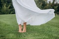 Bare feet bride soft green lawn movement