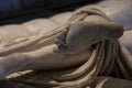 Bare feet of a carved marble statue in the museum there are many hard feet of ancient and historical style in greek art room