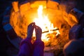 Bare feet of child by fire. Gatherings at night by campfire in open air in summer in nature. Family camping trip, gatherings Royalty Free Stock Photo