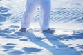 Bare feet of a child in white pants on the sand Royalty Free Stock Photo