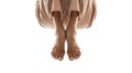 Bare feet crossed at the ankles, with a draped brown fabric, on a white background