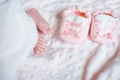 Bare feet of a cute newborn baby in warm white blanket. Childhood. Small bare feet of a little baby girl. Sleeping