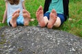 Bare feet of girl and boy on rock Royalty Free Stock Photo